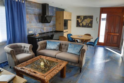 a living room with two couches and a table at Apartamento Azure- Tierra y Mar in Arrecife