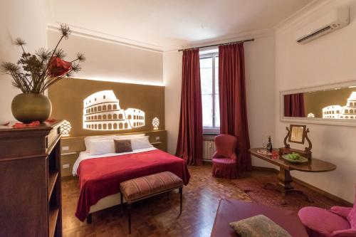 ローマにあるA Star Innの赤いベッドとテーブルが備わるホテルルームです。