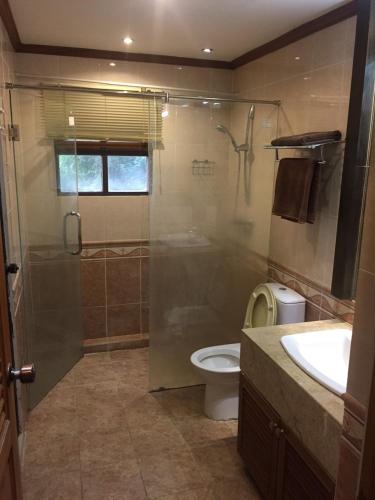 a bathroom with a shower and a toilet and a sink at Dolphinplace in Pattaya South