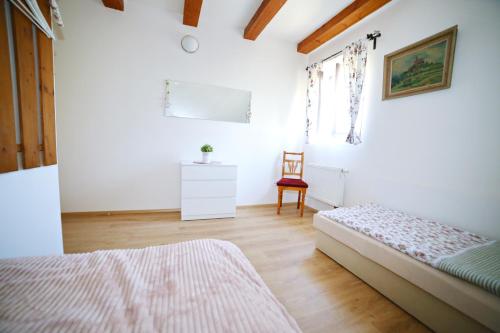 a bedroom with a bed and a chair in it at Restaurace a pension Chalupa in Vorder Třebau