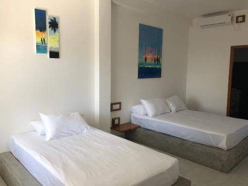 Postel nebo postele na pokoji v ubytování Dasu’s Restaurant & Villa