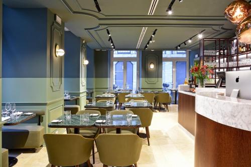 a restaurant with tables and chairs and blue walls at My Story Hotel Augusta in Lisbon