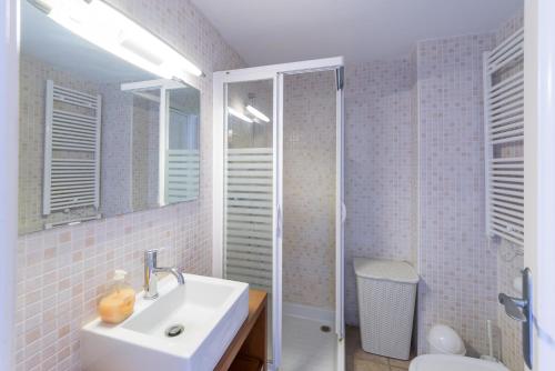 a bathroom with a sink and a shower and a toilet at Apartment Elena in L'Escala