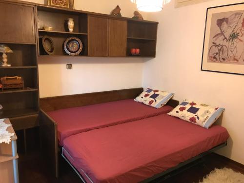 two beds in a room with red sheets at Luxury apartment close to city center, university and children's hospital in Athens