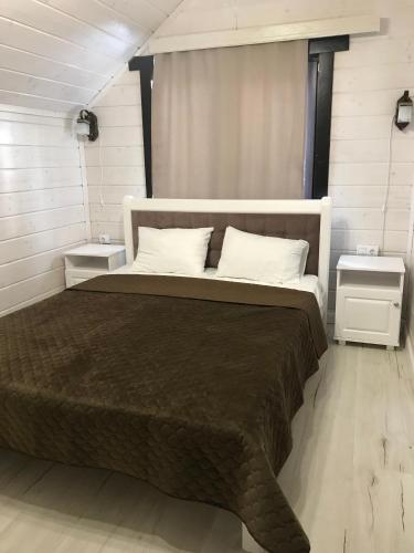 a bedroom with a large bed with two night stands at Villa Medova in Kosiv