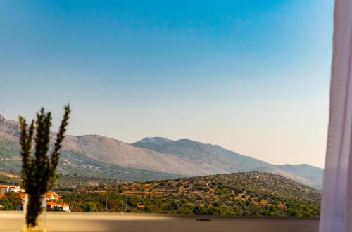 a view of a mountain range from a window at Apartmani Dalmacjia in Grebaštica