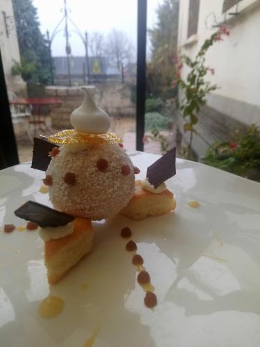 a plate of food with a cookie shaped like a snowman at Logis Hôtel restaurant Chez Jeannette in Fixin