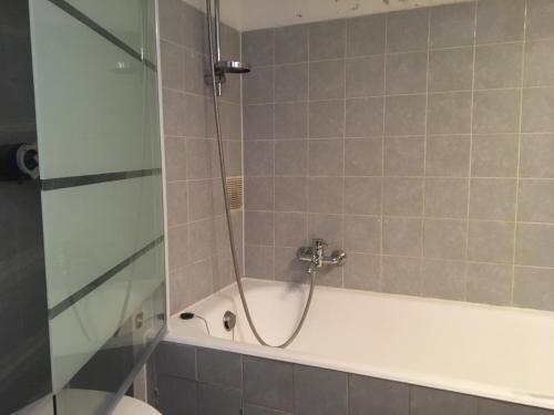 a shower in a bathroom with a bath tub at Studio Lora S 101 in Saint-Louis