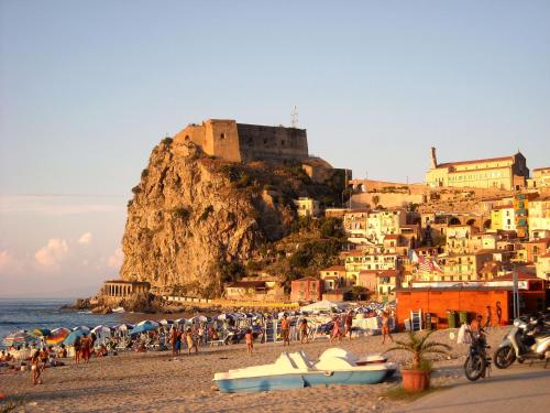 a group of people on a beach near the ocean at Casa vacanze Scilla in Scilla