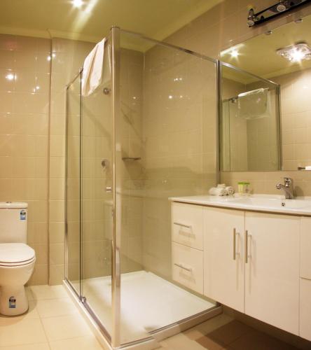 a bathroom with a shower and a toilet and a sink at Best Western Plus Buckingham International in Moorabbin