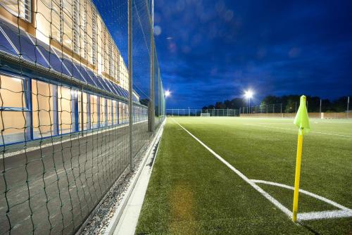 an empty soccer field at night with a goal at JUFA Hotel Fürstenfeld in Fürstenfeld