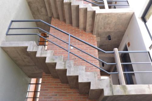 a staircase with steel railings in a building at VIÑA alquileres temporarios in San Salvador de Jujuy