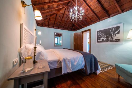 a bedroom with a bed and a table with a lamp at Casa Azul in Fuencaliente de la Palma