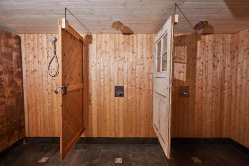 a room with wooden walls and an open door at Bio Aparthotel Blaslahof in Valle Di Casies