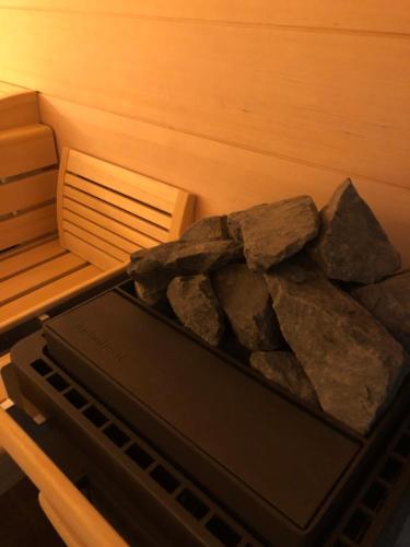 a tray of rocks in a sauna at Gîte Wellness Le Six H in Andolsheim