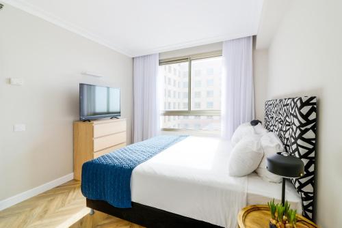 a bedroom with a large bed and a tv at master Haifa in Haifa