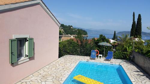 a swimming pool in the backyard of a house at Villa Lemonia in Kalami