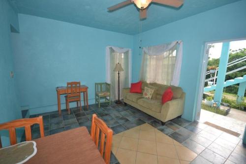a living room with a couch and a table at Lamblion Holiday Apartment in Freemans