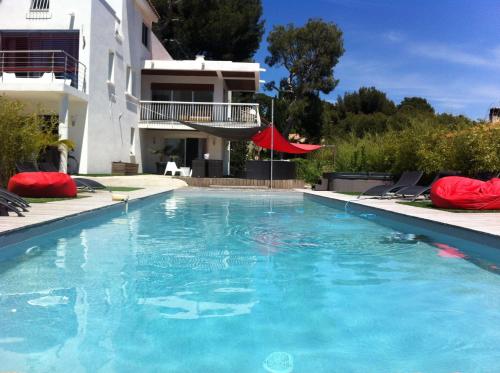 a swimming pool in front of a house at Villa W in Cassis