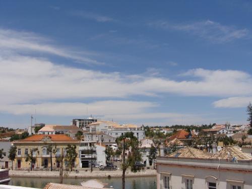 a city with a body of water and buildings at Aguarela Tavira in Tavira