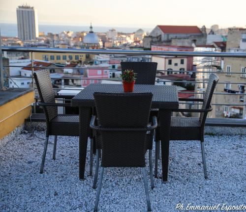 a table and chairs on a balcony with a view at B&B Nel Regno di Napoli in Naples