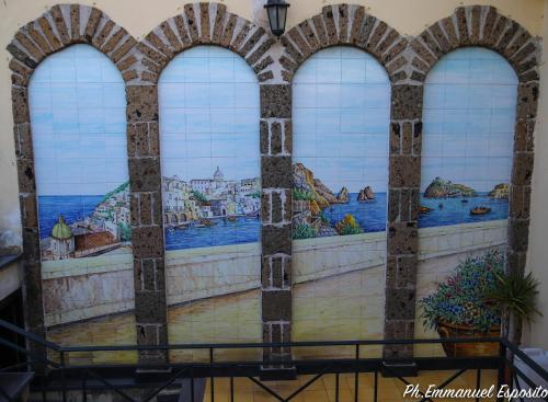 a mural on the side of a wall in a building at B&B Nel Regno di Napoli in Naples