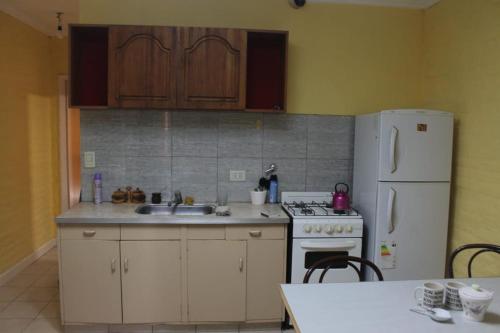 a kitchen with a sink and a white refrigerator at Avellaneda 1247 in Tandil
