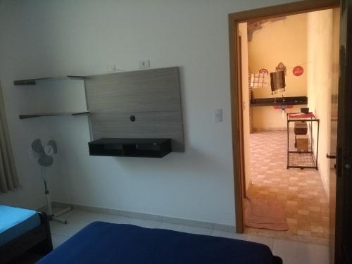 a room with a door to a room with a bedroom at Casa de praia litoral norte SP in Caraguatatuba
