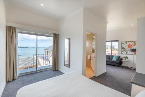 a bedroom with a bed and a view of the ocean at Bay 10 - Suites and Apartments in Port Lincoln