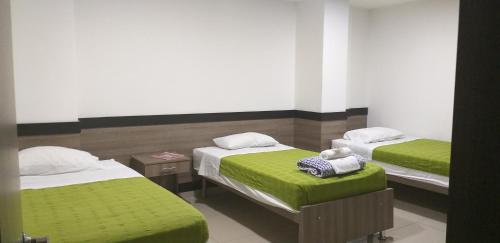 Postel nebo postele na pokoji v ubytování Hotel Ibague Plaza