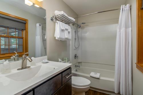 a bathroom with a sink and a toilet and a shower at Grey Fox Inn in Stowe