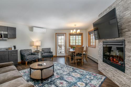 a living room with a couch and a fireplace at Grey Fox Inn in Stowe