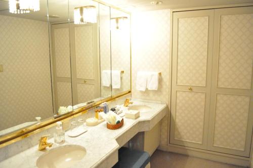 a bathroom with two sinks and a large mirror at Nagoya Tokyu Hotel in Nagoya