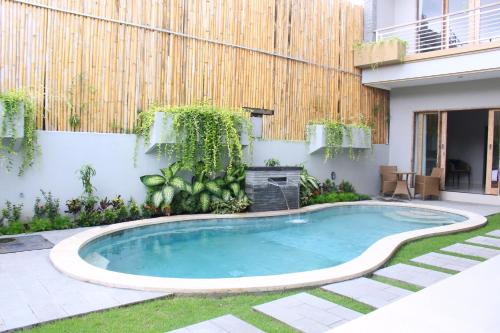 a swimming pool in the backyard of a house at Rusty Seminyak in Seminyak