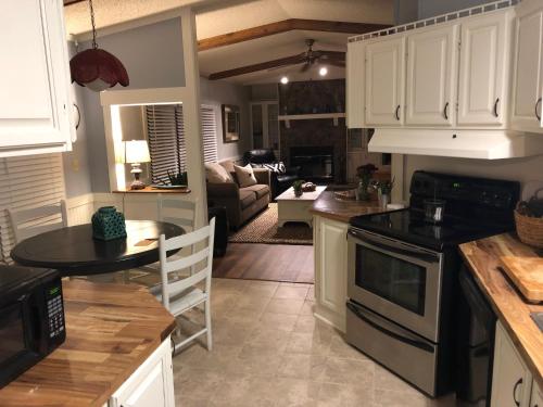 a kitchen and living room with a table and a stove at Beaufort SC New Renovation, Close to Parris Island, Historic Downtown, Beautiful Beaches, Sleeps 6 in Beaufort