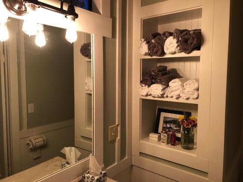 a bathroom with a sink and a mirror and towels at Beaufort SC New Renovation, Close to Parris Island, Historic Downtown, Beautiful Beaches, Sleeps 6 in Beaufort