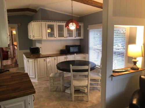 a kitchen with a table and chairs in a room at Beaufort SC New Renovation, Close to Parris Island, Historic Downtown, Beautiful Beaches, Sleeps 6 in Beaufort