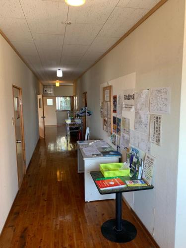 an office with a desk and papers on the wall at Minshuku Nodoka in Yakushima