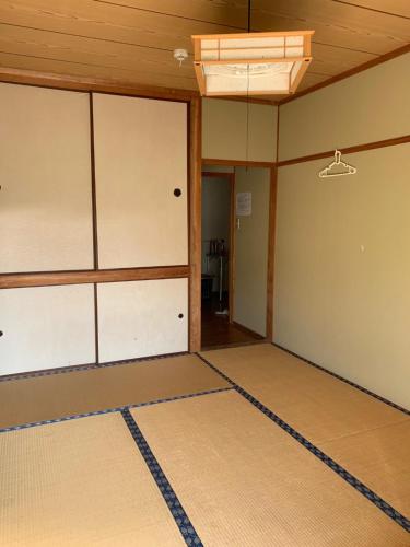 
an empty room with a door open at Minshuku Nodoka in Yakushima
