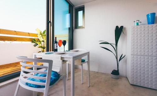 a dining room with a table and two chairs at Studio Sal in Albufeira