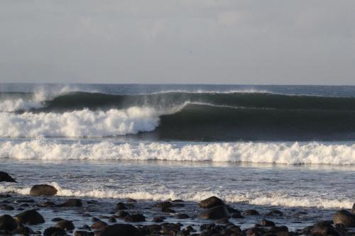 a group of waves crashing on a beach at Medewi Beach Inn in Pulukan