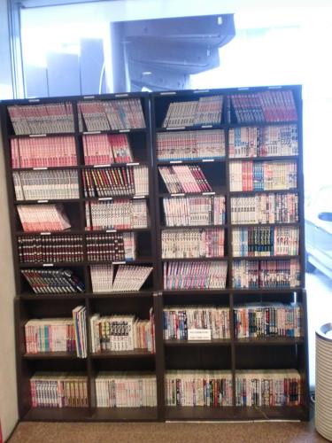 a book shelf filled with lots of dvds at Tsuyama Central Hotel Townhouse in Tuyama