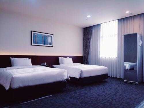 Postel nebo postele na pokoji v ubytování Geosung Hotel