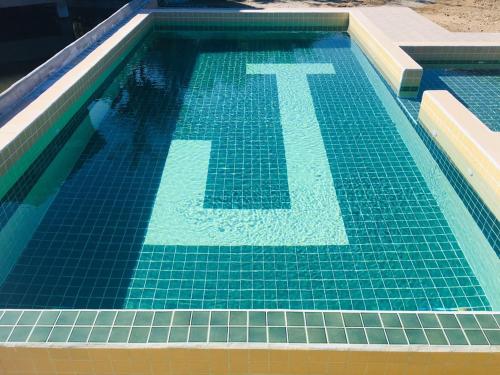 a swimming pool with a letter t in the water at JJ&J Garden in Pai