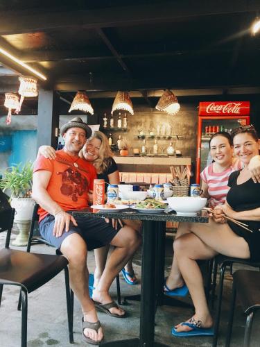 a group of people sitting at a table in a restaurant at Sunny Riverside Homestay in Hoi An