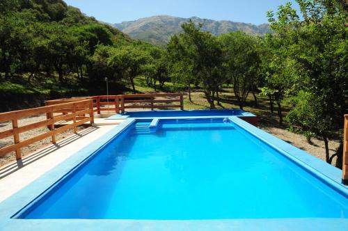 a swimming pool with a mountain in the background at Corazon de Montaña in Merlo