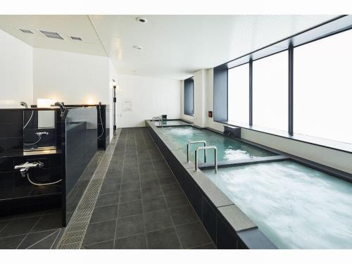 a large pool of water in a building at Hotel Lumiere Grande Nagareyama-Otakanomori in Nagareyama
