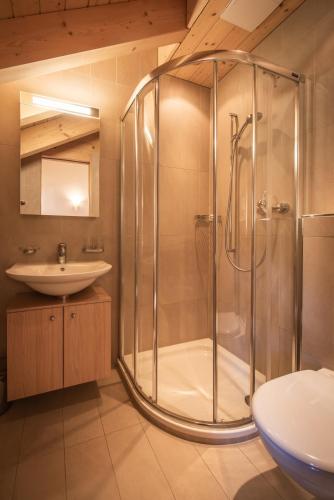 a bathroom with a shower and a sink at Chalet Aquila 8 Penthouse in Wengen