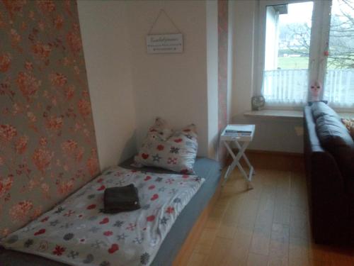 a small room with a bed and a window at Mia und Michel im Sauerland in Bad Berleburg
