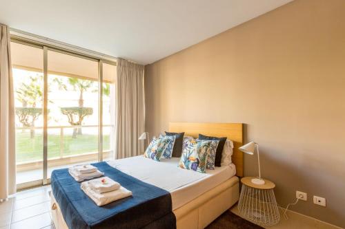a bedroom with a bed and a large window at Apartments Maria - Salgados 10A0D in Albufeira